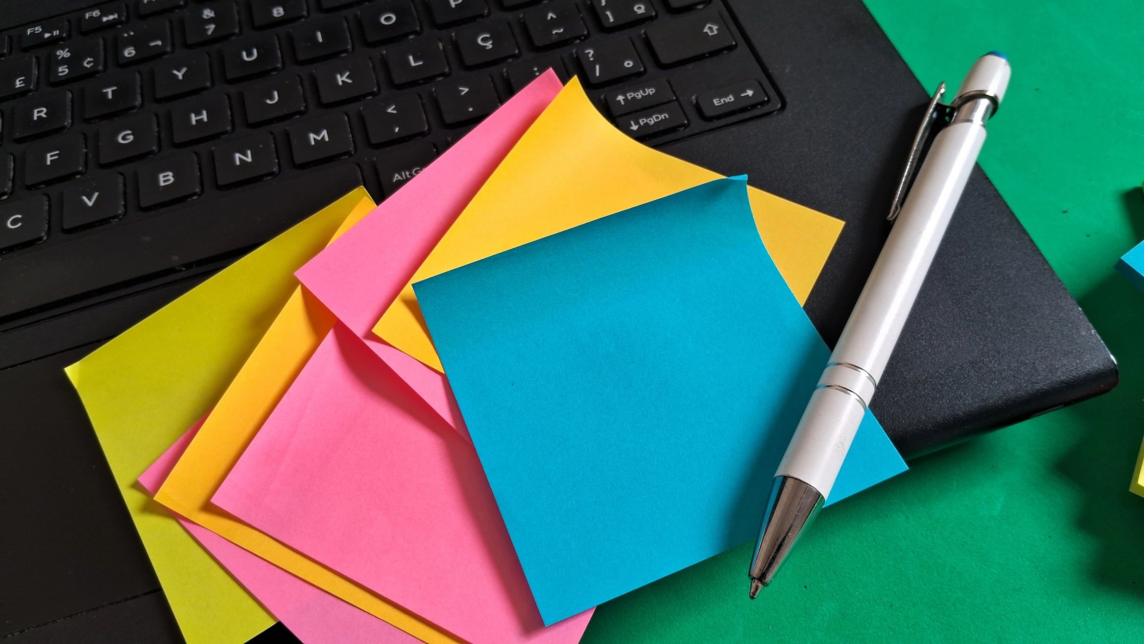 Content planning workspace with sticky notes and laptop
